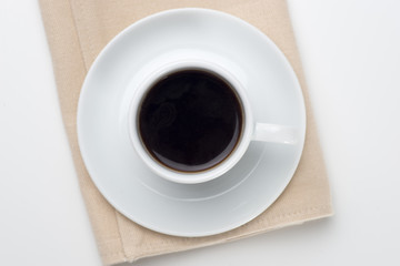 Obraz na płótnie Canvas Cup of coffee on table napkin