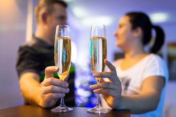 Couple on the romantic date with flutes of champagne