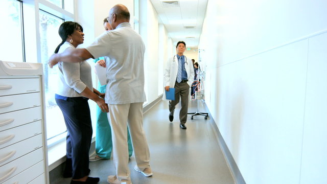 Caucasian female nurse consulting with African American couple in medical center