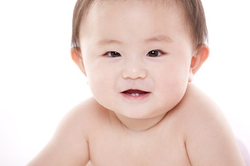 Studio shot of cute baby lying on floor