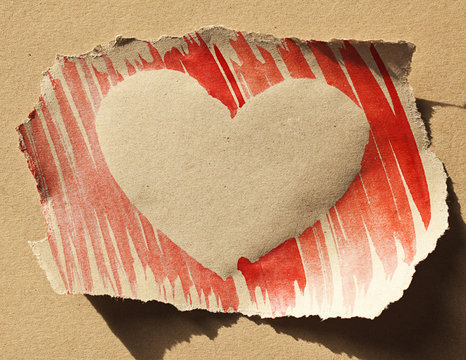 Postcard with handmade red heart on grunge, sepia background