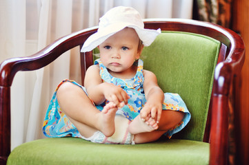 baby girl sitting on the chair