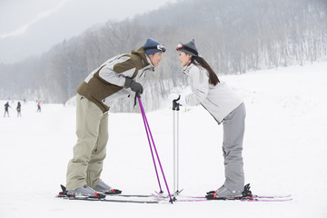Young couple skiing in ski resort