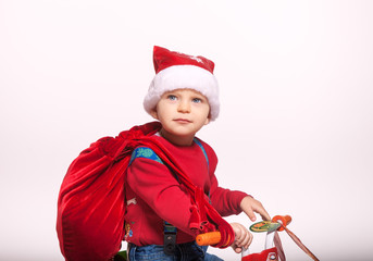 Boy dressed as Santa Claus with gifts