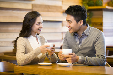 Young couple chatting in cafe