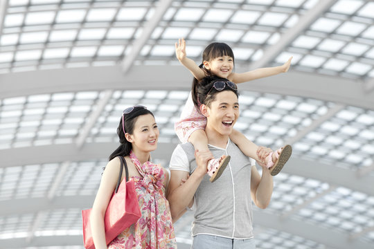 Cheerful Young Family At The Airport