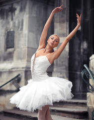 Leaning to the sky. Cropped shot of a young ballet dancer looking at the camera while dancing outdoors soft focus © serhiibobyk
