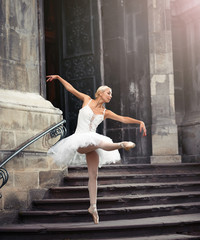 Naklejka premium Imagine her performing. Full length shot of a talented ballerina dancing near an old castle