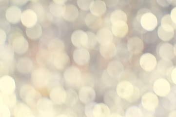 Light blurred background with white bokeh lights on it. Festive holiday theme with copyspace