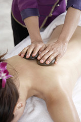 Obraz na płótnie Canvas Woman Receiving A Hot Stone Massage
