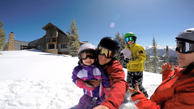 portrait young Caucasian family parents boy girl outdoor snow ski resort sport