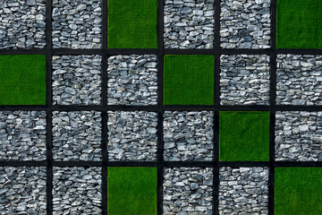 Rock and green artificial grass wall