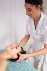Obraz na płótnie Canvas Young sexy woman in spa gets a facial massage
