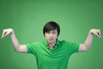 Man in green on green background practicing kung fu