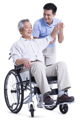 Male nursing worker helping senior man doing exercise