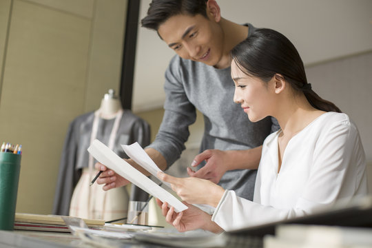 Two fashion designers drawing sketch