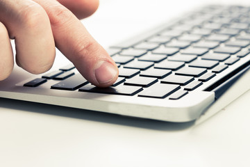 Close-up of typing male hands