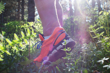 Close up of man walking on nature trail near forest preserve. Co