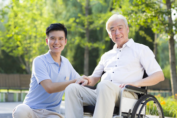 Wheelchair bound man with nursing assistant
