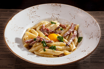 Pasta Carbonara with chicken egg yolk and parsley.