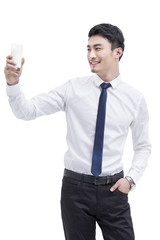 Happy young businessman with milk