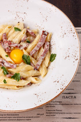 Pasta Carbonara with chicken egg yolk and parsley.