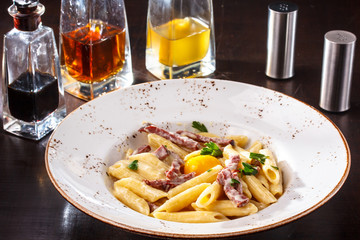 Pasta Carbonara with chicken egg yolk and parsley.