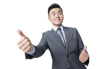 Young businessman giving thumbs up