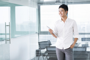 Young man with digital tablet in office