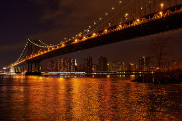 Manhattan Bridge and skyline view from Brooklyn at night