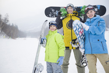 Young family with snowboards on the snow