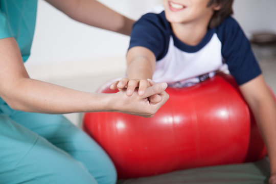 Therapist woman with boy in rehab