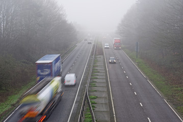 Traffic on a Misty Road. Logos removed or blurred to be unrecognisable