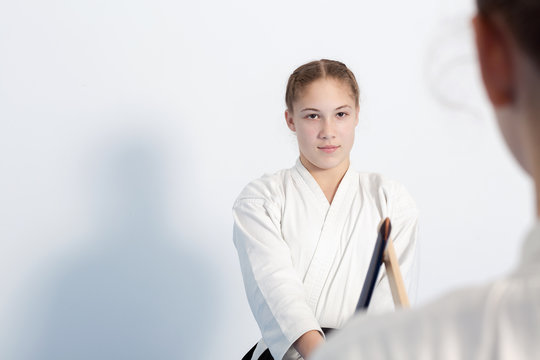 Two girls have their sword practice on Aikido training on white background