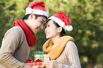 Young Couple Exchanging Christmas Gifts