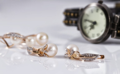 gold jewelry with pearls and elegant women's watches