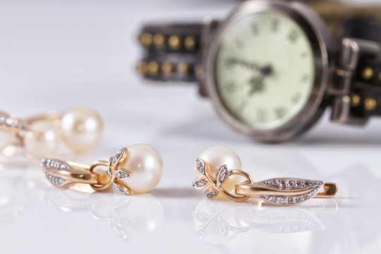 gold jewelry with pearls and elegant women's watches