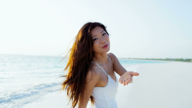 Portrait of carefree Asian Chinese female on tropical beach