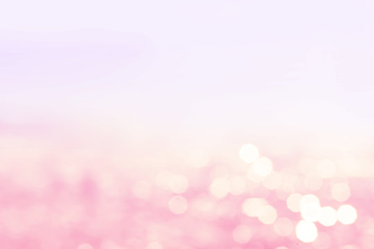 Lights blurred bokeh background in sunny summer day on a beach.