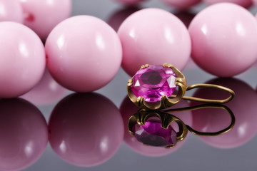 gold earring with ruby and large pink beads