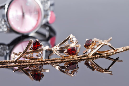 Gold earrings with rubies and elegant women's watches