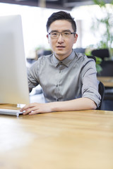 Young man using computer in office