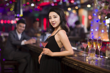 Obraz na płótnie Canvas Cheerful young woman in bar