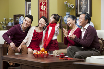 Happy family singing karaoke during Chinese New Year