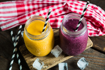 Smoothies in jar on a wooden table