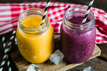 Smoothies in jar on a wooden table
