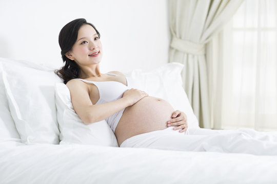 Pregnant woman resting in bed