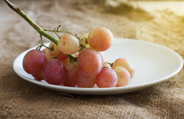 Still Life-Red grapes in white container