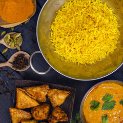 Indian pilau rice in balti dish served with chicken tikka masala