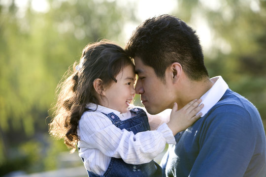 Father and daughter rubbing noses 